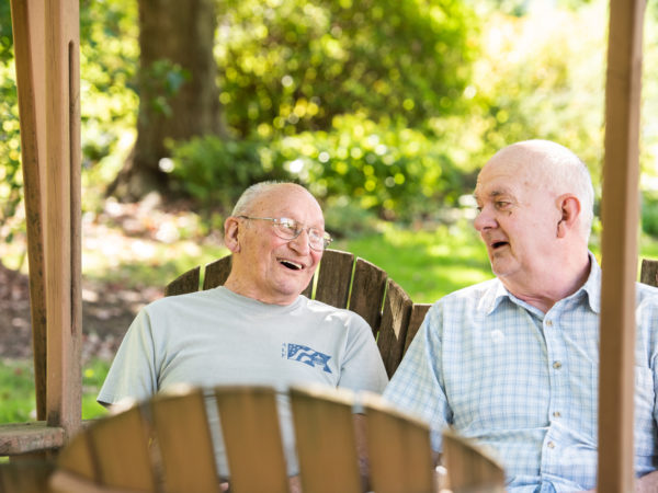 Two residents outdoors talking