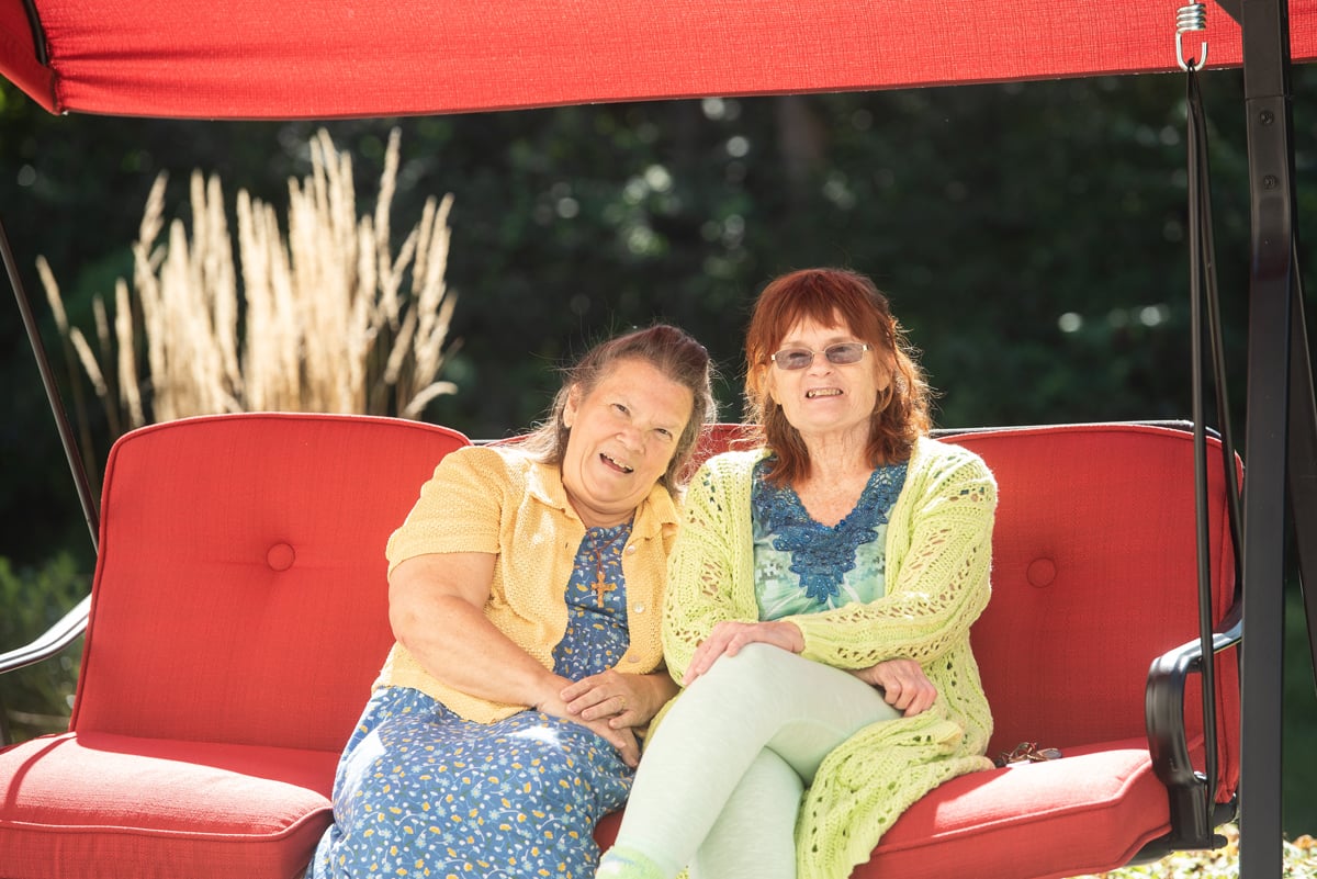 two seniors talking at kitchen table