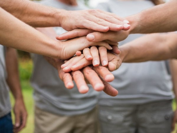 volunteer hands stacked on one another