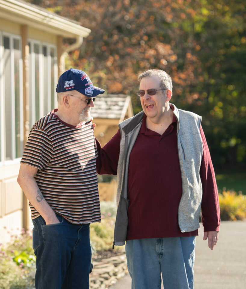 Two male residents talking outside